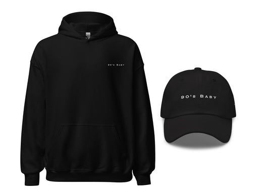 black hoodie and dad hat both with an embroidered message that says 90's baby
