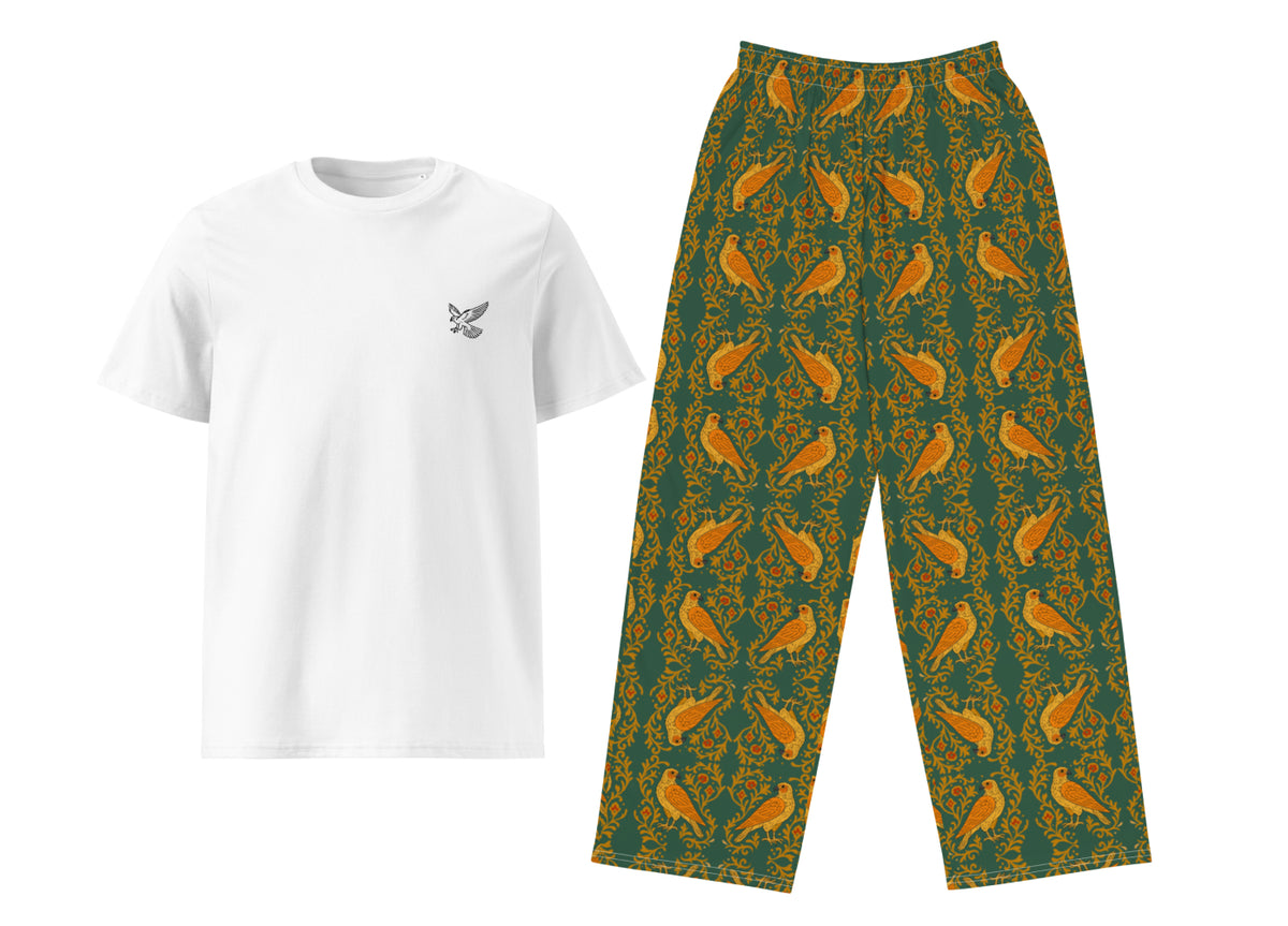 White t-shirt with a small falcon and green patterned pants on a white background