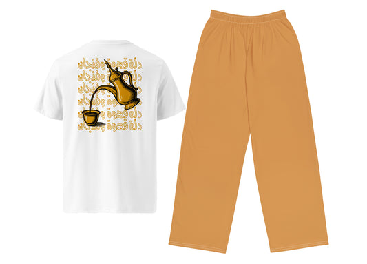 White t-shirt with Arabic text and a coffee pot graphic on a white background, paired with light brown pants