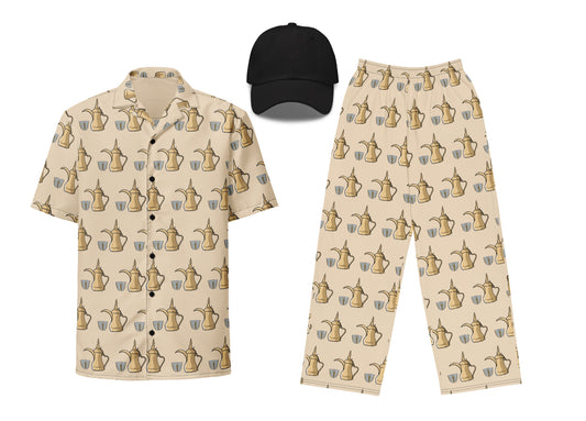 A set of clothing featuring a beige unisex button shirt and pants with a dallat gahwa pattern, and a black unisex embroidered dad hat.