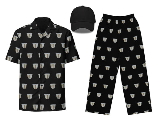 A set of apparel featuring a black unisex button shirt with a finjan pattern, black unisex wide-leg pants with a similar pattern, and a black dad hat