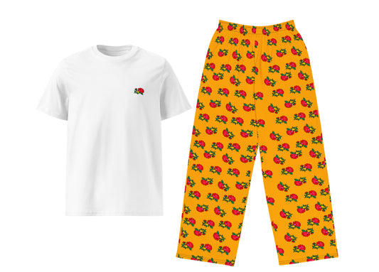 White t-shirt with a small flower and yellow pants with fruit pattern on a white background