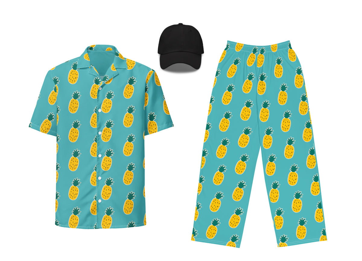 Set of pineapple-patterned shirt, pants, and cap on a white background