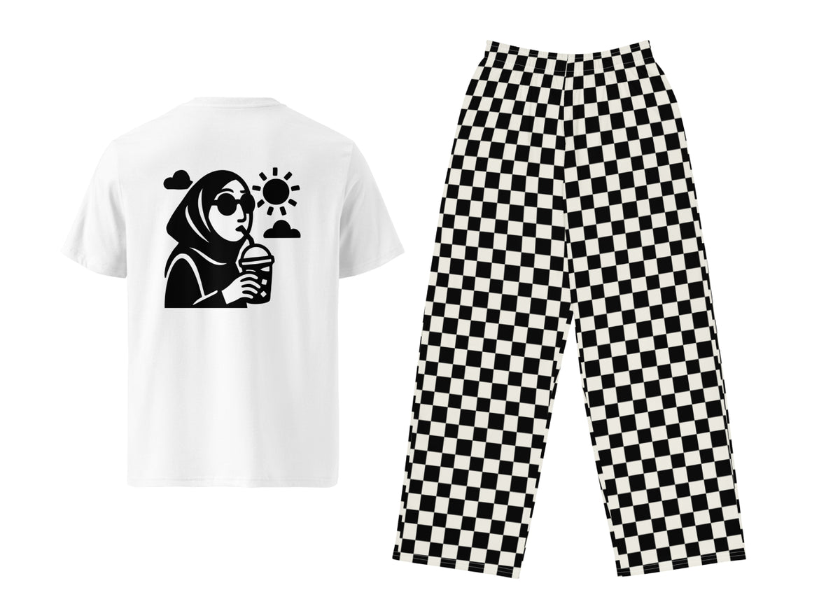 White t-shirt with graphic design and black checkered pants on a white background