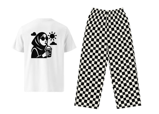 White t-shirt with graphic design and black checkered pants on a white background