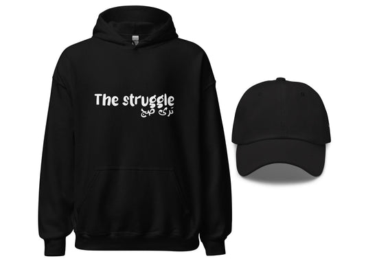 A black hoodie with the text 'THE STRUGGLE IS REAL' on the front and a matching black dad hat.