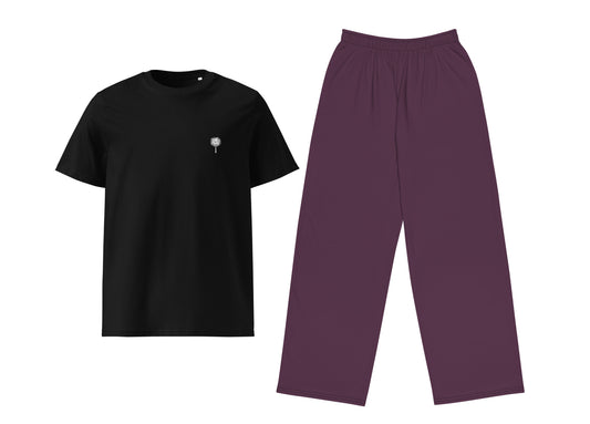 Black t-shirt with a small white palm tree and purple pants on a white background