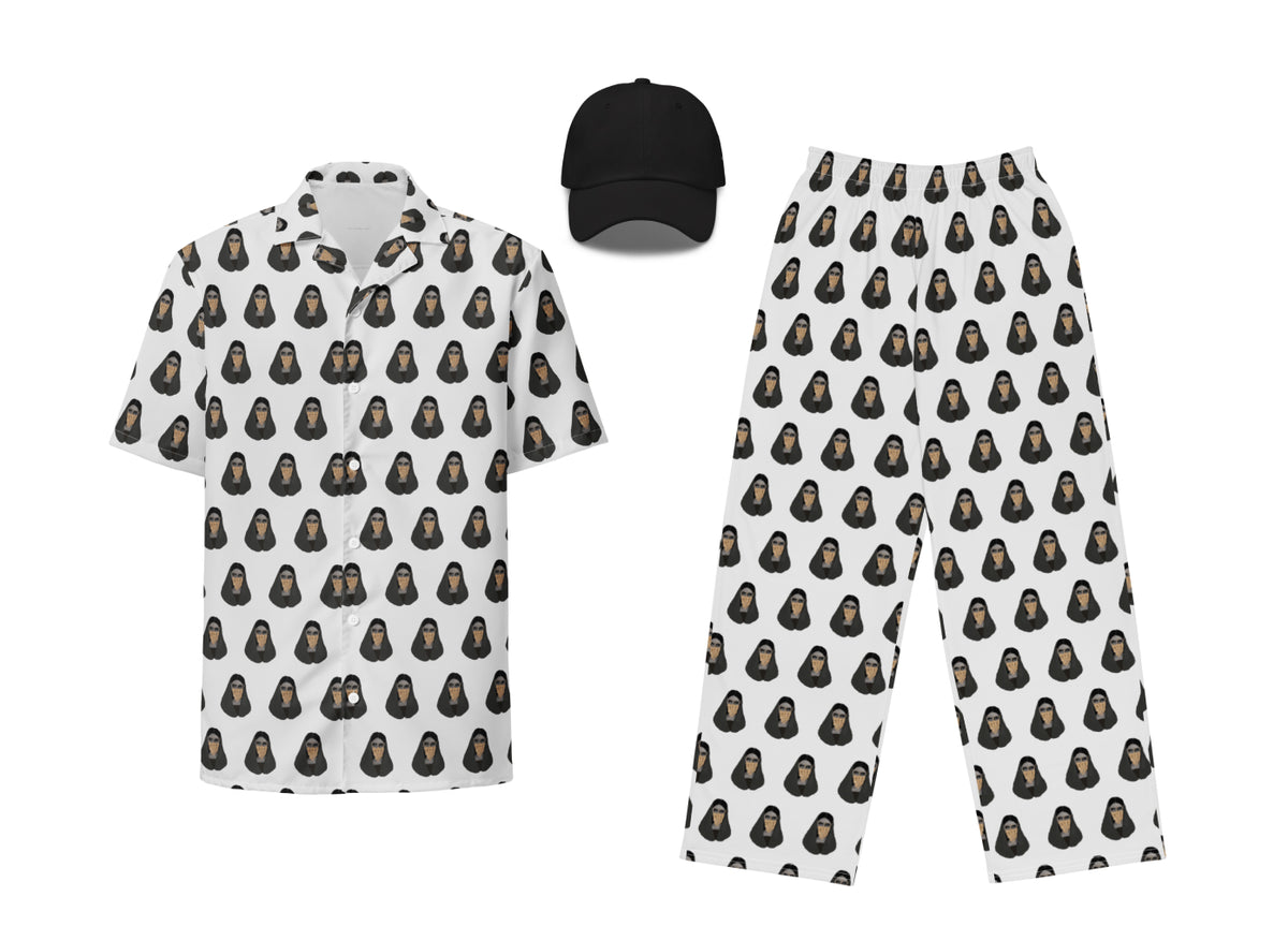 A set of black and white apparel featuring a geometric burqa pattern, including a button shirt, pants, and a hat.