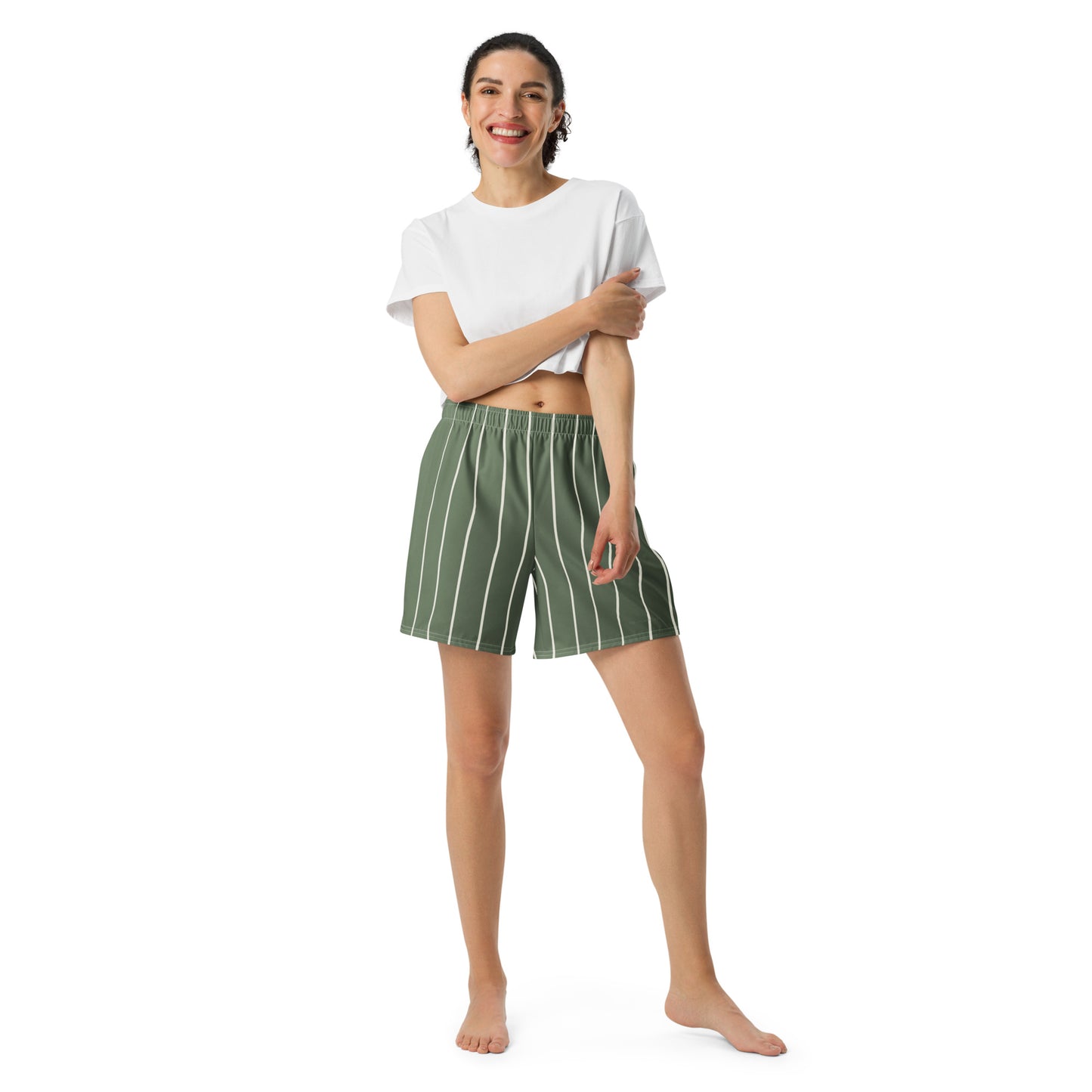 Woman wearing a white t-shirt and green striped shorts on a white background