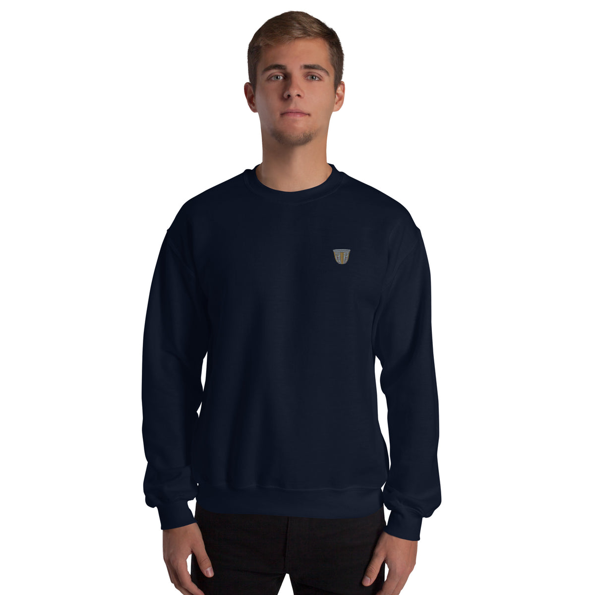 Person wearing a navy blue sweatshirt with a small embroidered finjan on a white background