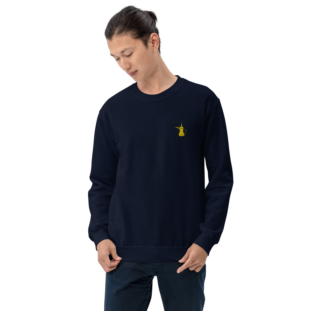 Person wearing a navy blue sweatshirt with a yellow dallah on a white background