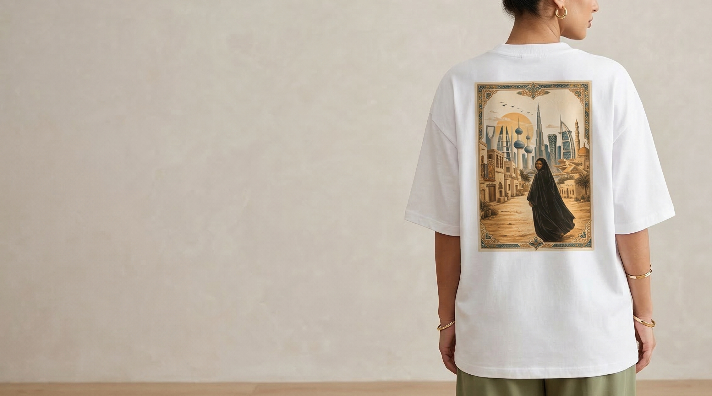 Person wearing a white t-shirt with a graphic design on the back, standing against a plain background.