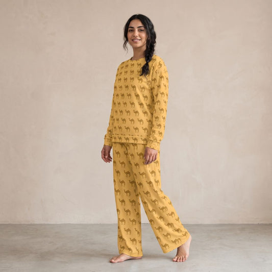 Model wearing a mustard yellow sweatshirt and matching wide-leg pants with an all-over camel print.