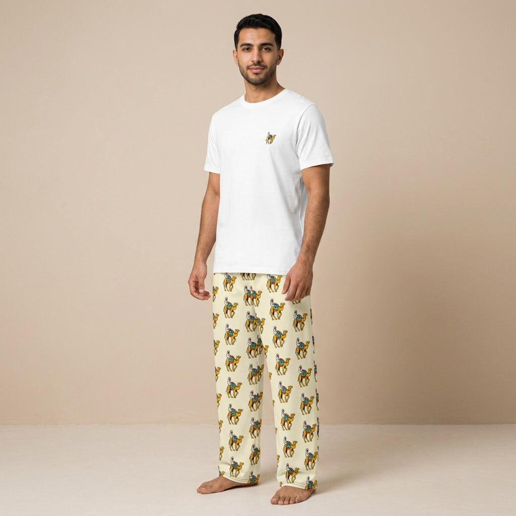 Model wearing a white T-shirt with a small camel rider motif and cream pants with an all-over camel rider print.