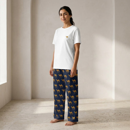 Model wearing a white T-shirt with a small camel motif and navy wide-leg pants patterned with golden camels.