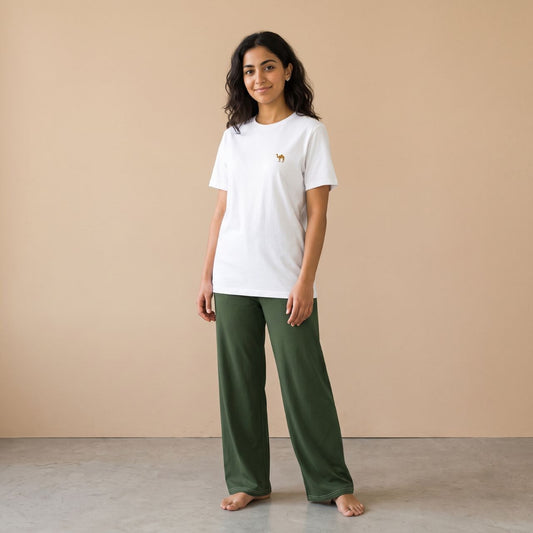 Model wearing a white T-shirt with a small camel motif and plain dark green wide-leg pants, front view.