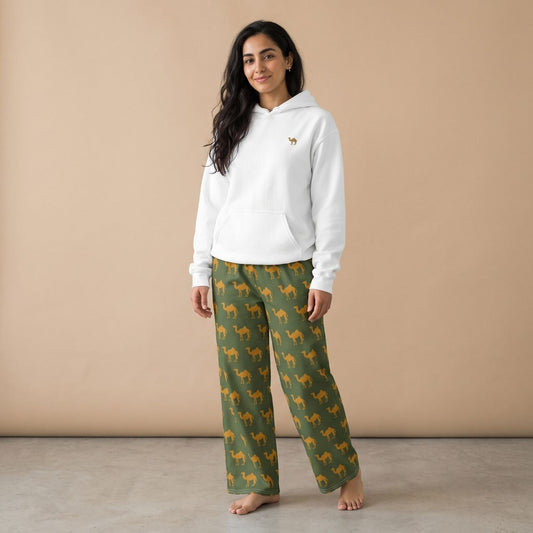 Model wearing a white hoodie with a small camel motif and olive green pants with golden camel prints, front view.