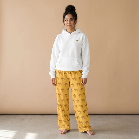 Model wearing a white hoodie with a small camel motif and golden yellow pants with brown camel prints, front view.