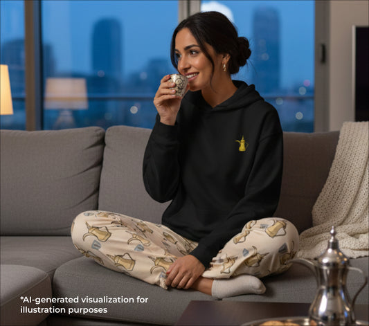 Woman sitting on a couch drinking from a finjan with a cityscape in the background