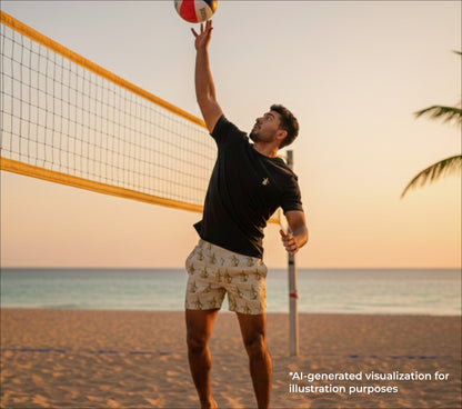 Man playing beach volleyball on a sandy court with ocean and sunset in the background