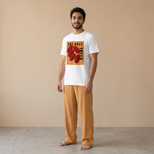 Model wearing a white dates graphic T-shirt with “The Only Dates I Need” text and mustard yellow pants, front view