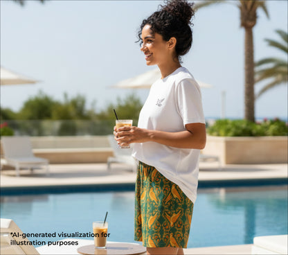 Woman holding a drink by a pool with palm trees in the background