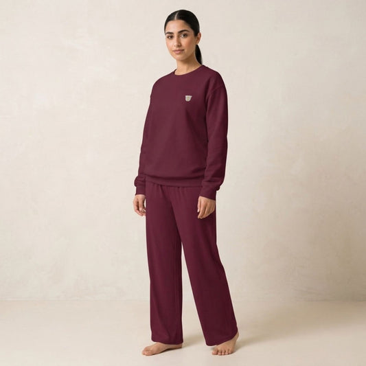 Model wearing the maroon Finjan sweatshirt with small coffee cup embroidery on the chest and matching wide-leg pants.