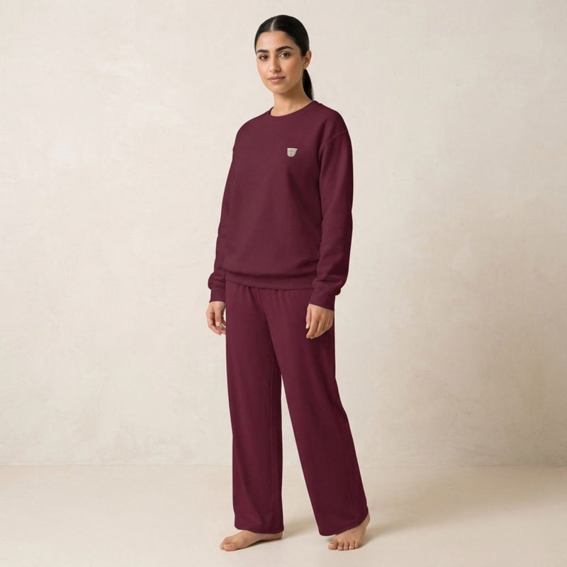 Model wearing the maroon Finjan sweatshirt with small coffee cup embroidery on the chest and matching wide-leg pants.