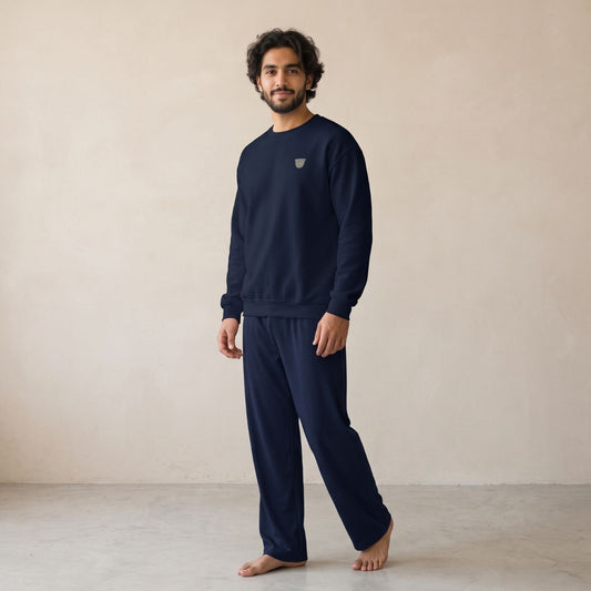 Model wearing a navy sweatshirt with a small finjan coffee cup chest motif and matching wide-leg pants.