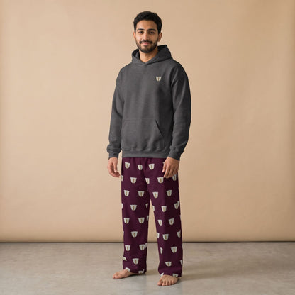 Model wearing a dark grey hoodie with a small finjan cup motif and maroon pants with white finjan cup prints, front view.