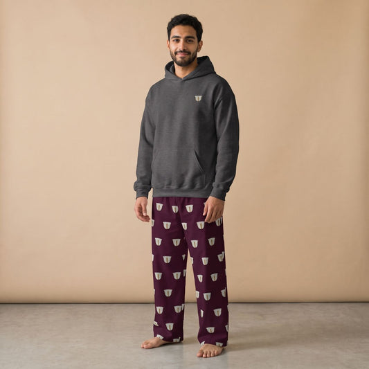 Model wearing a dark grey hoodie with a small finjan cup motif and maroon pants with white finjan cup prints, front view.