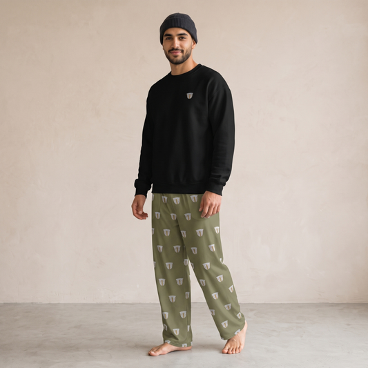 Model wearing a black sweatshirt with small coffee cup embroidery and khaki wide-leg pants with a repeating finjan cup print.