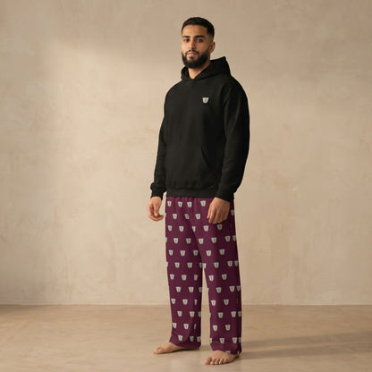Model wearing a black hoodie with a small finjan motif and matching maroon pants with an all-over finjan print.
