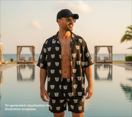 Man wearing a finjan patterned shirt and shorts by a pool 