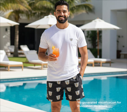 Man holding a drink by a pool with pool chairs and umbrellas in the background