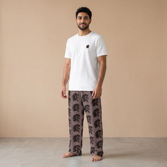 Model wearing a white T-shirt with a small horse head motif and taupe pants with black horse head prints, front view.