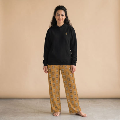 Model wearing a black hoodie with a small karak tea glass motif and mustard yellow pants with karak tea glass prints, front view.