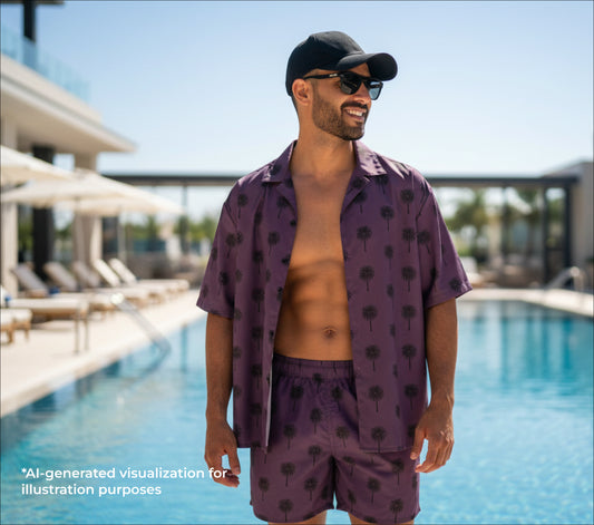Man wearing a purple palm tree patterned shirt and shorts by a pool