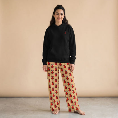 Model wearing a black hoodie with a small red tea glass motif and beige pants with red tea glass prints, front view.