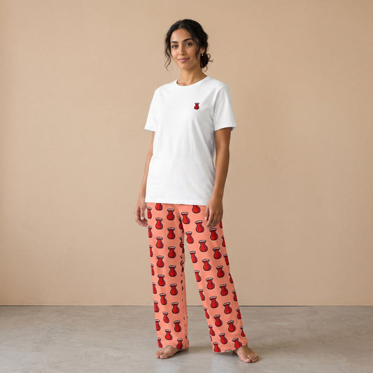 Model wearing a white T-shirt with a small red tea glass motif and pink pants with red tea glass prints, front view.