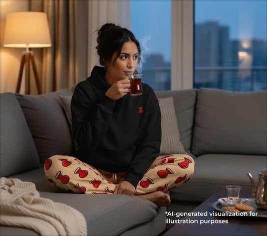 Woman sitting on a couch holding a cup of tea with a cityscape view in the background