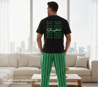 Person wearing a black t-shirt with 'Saudi Arabia' text in multiple languages in a living room.