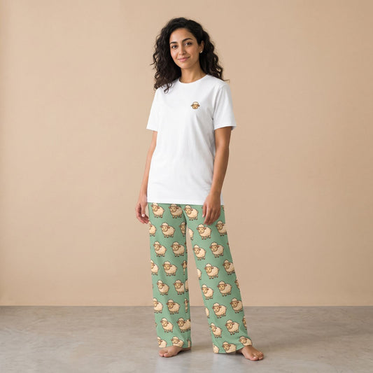 Model wearing a white T-shirt with a small sheep motif and mint green pants with an all-over cartoon sheep print, front view.