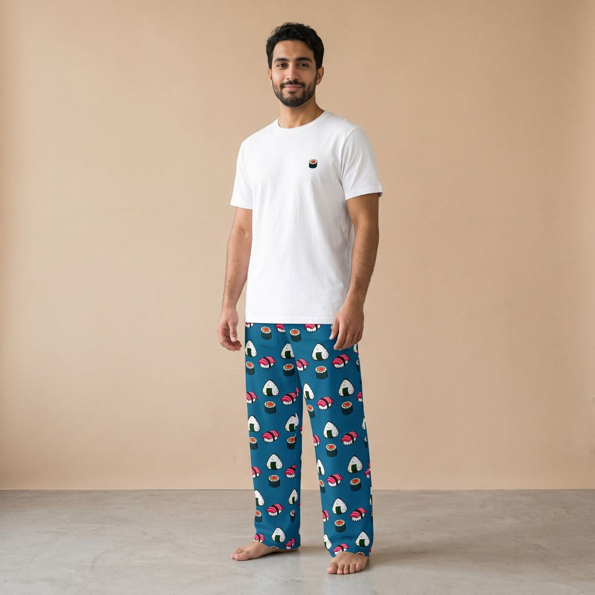 Model wearing a white T-shirt with a small sushi motif and cerulean blue pants with sushi and onigiri prints, front view.