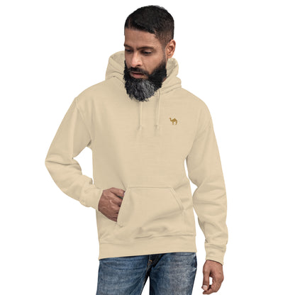 Man wearing a beige hoodie with a small embroidered camel on a white background
